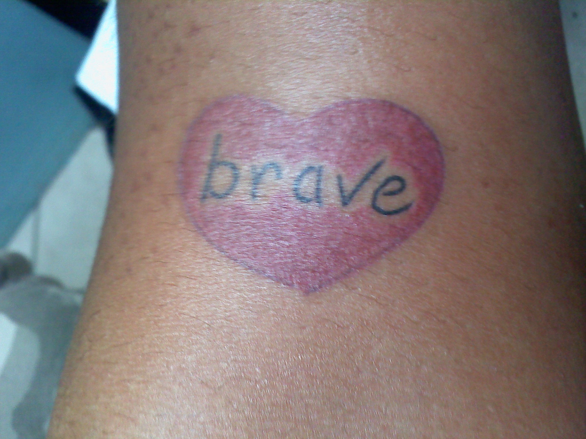 A tattoo of a heart with the word brave. Photo by: tanjila ahmed, Creative Commons