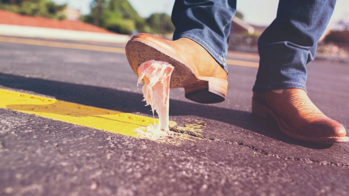 A person has stepped in chewing gum and it's stuck to their boot in the middle of a road. Image: Gratisography