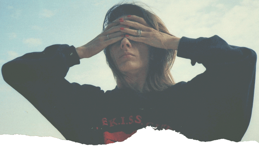 A woman covers her eyes to illustrate how difficult it is to make decisions.